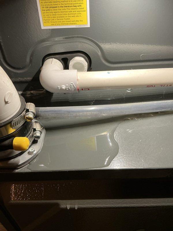 Responded to no cooling complaint on residential HVAC system. Upon inspection, found unit not operating. Examined interior components including condensate drain system, PVC piping, and ductwork connections. Documented condition of drain pan with standing water present and verified all mechanical connections and hose clamps secure. System restored to proper operation.
