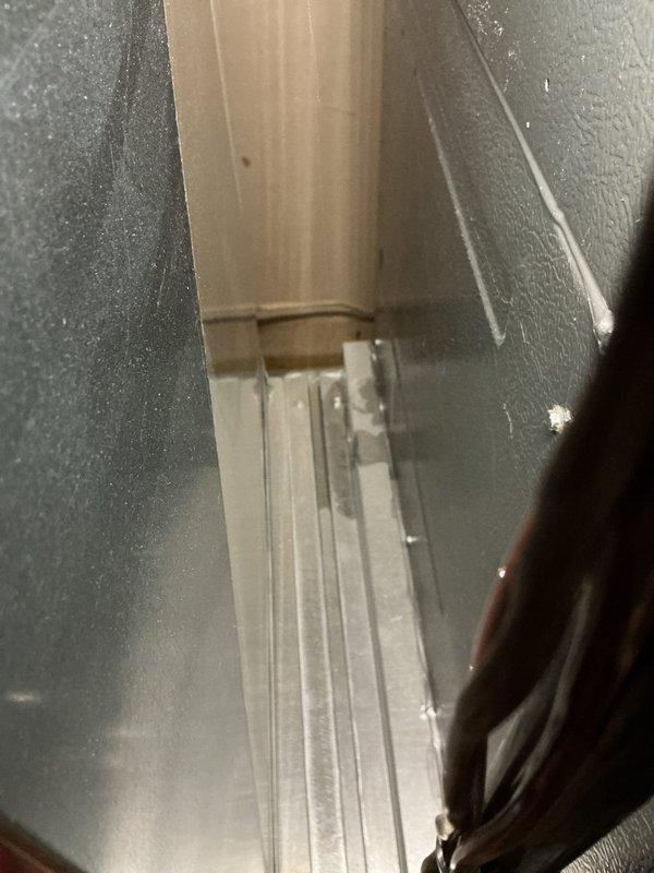 Responded to no cooling complaint on residential HVAC system. Upon inspection, found unit not operating. Examined interior components including condensate drain system, PVC piping, and ductwork connections. Documented condition of drain pan with standing water present and verified all mechanical connections and hose clamps secure. System restored to proper operation.