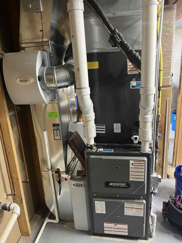 Completed annual cooling maintenance on residential HVAC system with Amana thermostat showing 69°F current temperature and set to 70°F cooling mode. Inspected furnace unit, Aprilaire humidifier, ductwork connections, and PVC condensate drainage system; all components found operating within normal parameters with no issues identified.