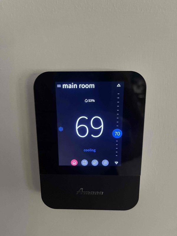 Completed annual cooling maintenance on residential HVAC system with Amana thermostat showing 69°F current temperature and set to 70°F cooling mode. Inspected furnace unit, Aprilaire humidifier, ductwork connections, and PVC condensate drainage system; all components found operating within normal parameters with no issues identified.