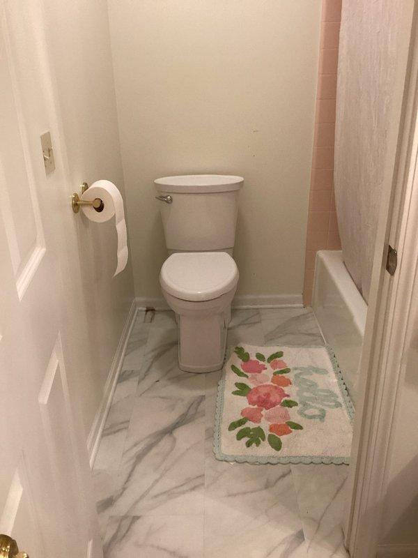 Responded to report of leaking toilet in residential bathroom. Upon arrival, assessed 4-6 year old toilet fixture showing signs of water seepage at base. Shut off water supply at angle stop valve and disconnected supply line. Removed toilet mounting bolts and carefully lifted fixture to expose flange and existing wax ring. Confirmed deteriorated wax ring as source of leak, with visible water damage and discoloration on subflooring around flange. Scraped away old wax ring material and cleaned toilet horn and closet flange thoroughly to ensure proper seal. Inspected flange for damage or deterioration; found flange in acceptable condition with secure anchoring to subflooring. Installed new wax ring with plastic horn onto closet flange, ensuring proper alignment. Repositioned toilet over flange, carefully aligning mounting bolt holes. Pressed toilet firmly into place to compress wax ring and create watertight seal. Reinstalled and torqued closet bolts evenly to manufacturer specifications,