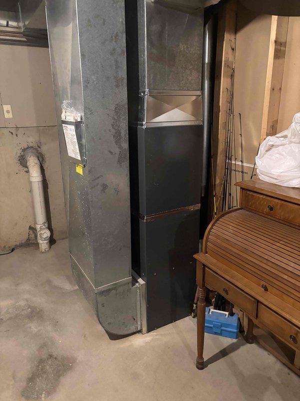 Completed full HVAC system replacement including installation of new air conditioning condenser unit on exterior concrete pad and new furnace/air handler in basement. Established proper refrigerant line connections between outdoor condenser and indoor coil system, installed condensate drain line with PVC piping, and verified electrical connections to both units. Tested system operation for proper cooling cycle, airflow, and temperature differential across the coil to ensure optimal performance and efficiency of the complete system.