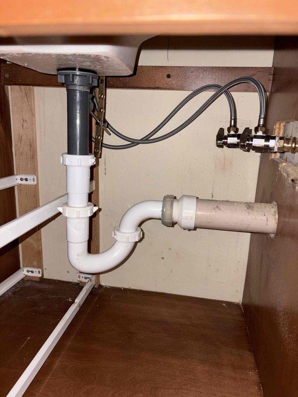 Responded to callback for leaking faucet that had been recently replaced. Upon inspection, verified active leak at bathroom sink faucet with water running into basin. Troubleshot the installation to identify source of leak. Adjusted and properly secured faucet connections, ensuring all supply line fittings were tight and sealed correctly. Verified P-trap assembly and drain connections were functioning properly with no additional leaks present. Tested faucet operation and confirmed leak was resolved with no further water discharge.
