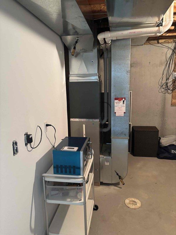 Completed full air conditioning system replacement in basement mechanical room. Removed existing AC unit and installed new condensing unit with corresponding evaporator coil. Connected new equipment to existing furnace and ductwork system using properly sized refrigerant lines and black flexible duct transitions. Installed new condensate drain line with white PVC piping routed to existing drainage system. Made all necessary electrical connections and verified proper voltage and amperage at disconnect. Pressure tested refrigerant lines, evacuated system to proper micron level, and charged unit to manufacturer specifications. Commissioned system and verified proper airflow, temperature differential, and overall operation. All work performed to code and manufacturer guidelines.