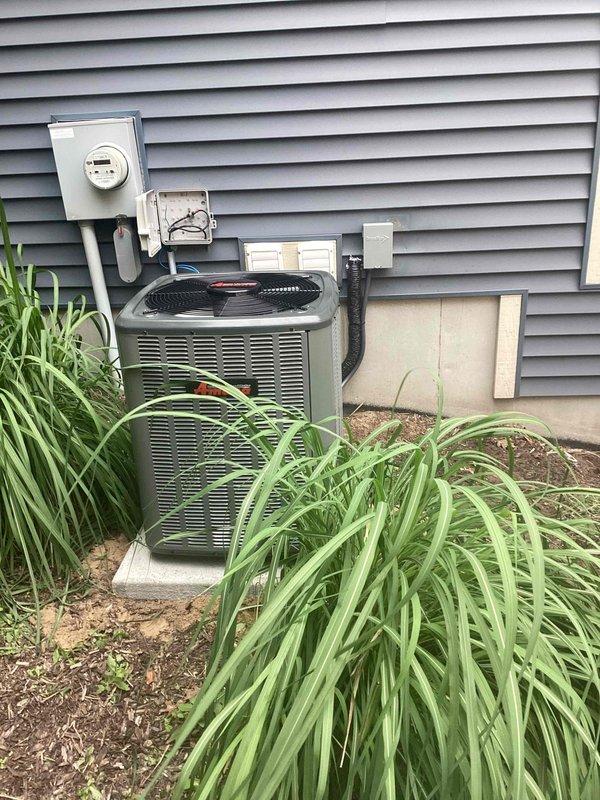 Completed full ACREP-AC system replacement including outdoor condensing unit and indoor air handler components. Removed existing equipment and installed new dark olive-green outdoor condenser unit on concrete pad with proper electrical connections to existing disconnect box and meter. Installed new furnace unit in basement utility area with integrated humidifier attachment and metallic supply ductwork. Verified all electrical connections, refrigerant lines, and condensate drainage systems functioning properly. Tested system operation and confirmed proper airflow, temperature differential, and thermostat communication. System commissioned and left in full operational status.