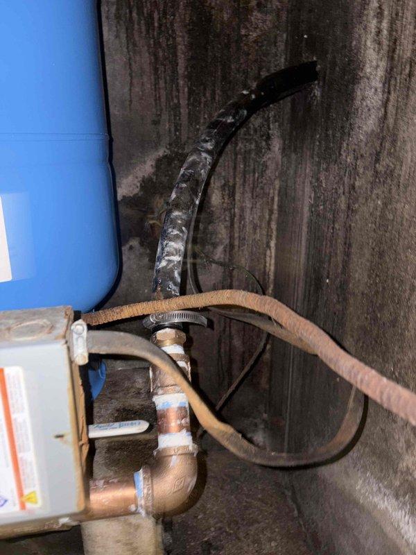 Completed comprehensive plumbing system repair on water heater installation with focus on pressure regulation and valve assembly replacement. Addressed deteriorated flexible connector hoses and corroded copper piping connections, installed new brass ball valves and pressure gauge assembly to restore proper system monitoring and flow control. Remediated moisture damage area and ensured all connections were properly sealed to prevent future water intrusion and corrosion issues.