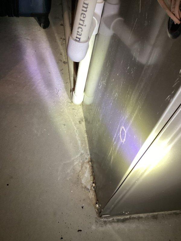 Responded to air conditioning service call for 9.5-year-old system experiencing cooling issues but still operational. Performed diagnostic inspection of HVAC unit and surrounding area, documenting conditions including moisture accumulation in utility room, condensate drainage concerns, and corrosion on plumbing connections. Photographed equipment and environmental conditions for service records.