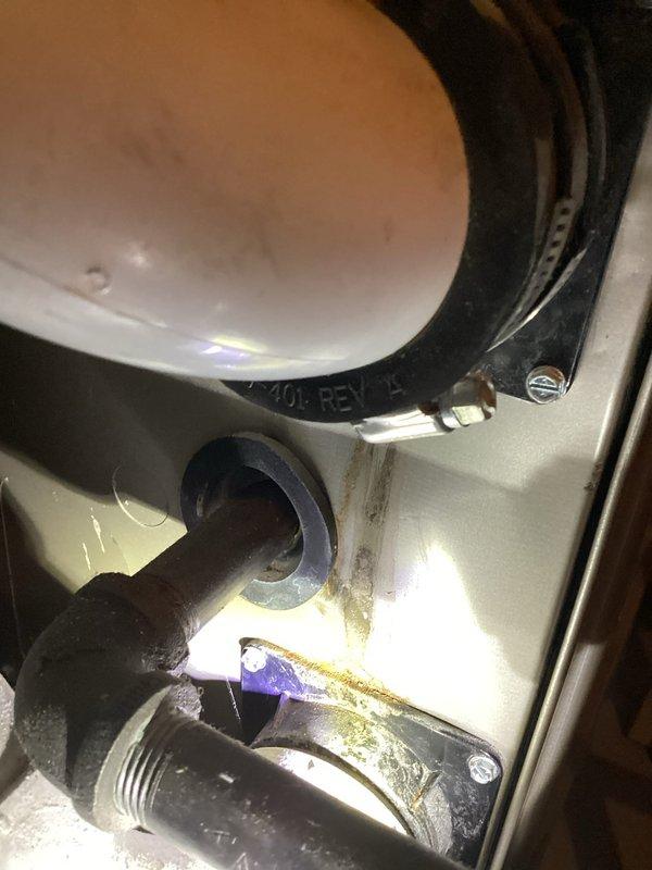 Responded to air conditioning service call for 9.5-year-old system experiencing cooling issues but still operational. Performed diagnostic inspection of HVAC unit and surrounding area, documenting conditions including moisture accumulation in utility room, condensate drainage concerns, and corrosion on plumbing connections. Photographed equipment and environmental conditions for service records.