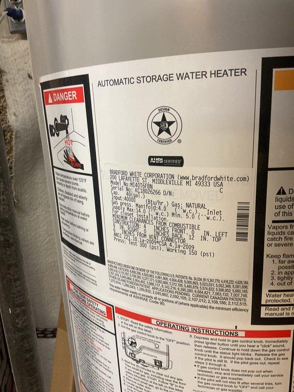 Responded to emergency call for 13-year-old Bradford White water heater experiencing steady water leak that extinguished pilot light and caused automatic system shutdown. Upon arrival, confirmed gas supply had been safely shut off by homeowner. Inspected unit and documented existing conditions with photographs showing dual water heater installation in basement utility area. Identified source of water intrusion causing safety shutdown of heating system. Unit displayed normal wear consistent with age and operational history.