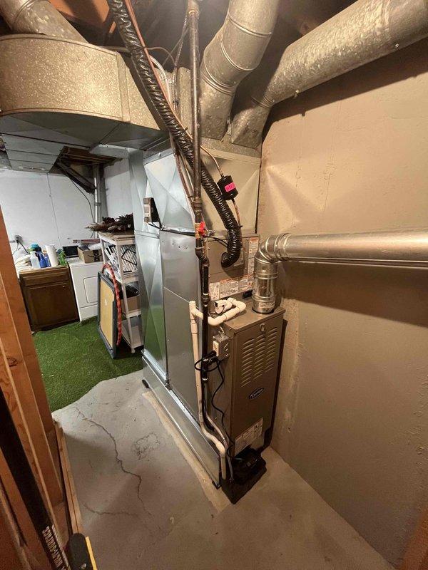 Completed full installation of residential furnace and air conditioning system in basement mechanical room. New furnace unit installed with proper venting, ductwork connections, and condensate drainage via PVC piping. All electrical connections, refrigerant lines, and flexible ductwork secured and tested for proper operation.