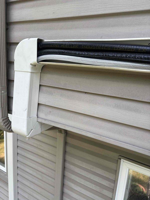 Responded to warranty call for mini-split system installed recently that was leaking water heavily. Inspected exterior wall-mounted air handler unit and refrigerant line set installation. Identified and resolved drainage issue causing water leak from indoor unit. System tested and confirmed operating properly with no further water discharge.