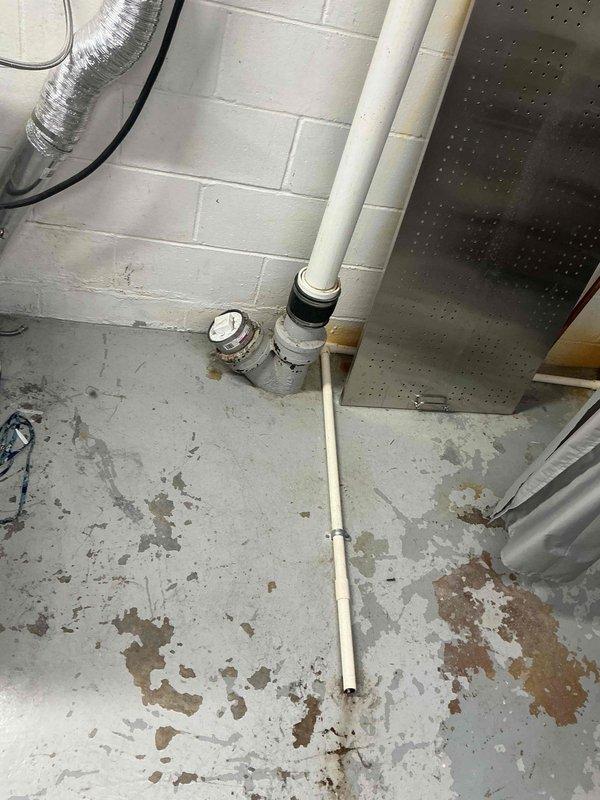 Responded to a main line drainage issue at the property. Upon arrival, inspected the basement utility area where the main sewer line is accessible through the concrete floor. The PVC cleanout pipe was located in the mechanical room near the gas meter and HVAC equipment. Documented existing conditions showing deteriorated flooring with moisture staining and aging infrastructure. Assessed the main line access point and surrounding plumbing connections to determine the scope of the drainage problem. Photographed the cleanout location and adjacent piping system for service records.
