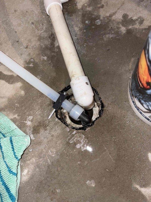 Responded to a clogged floor drain in basement utility area. Upon inspection, removed drain cover and cleared blockage from the drain line using appropriate drain cleaning equipment. Disassembled section of white PVC drain piping to access and remove accumulated debris causing the obstruction. Successfully restored proper drainage flow, reassembled all plumbing components, and tested system to verify complete functionality.