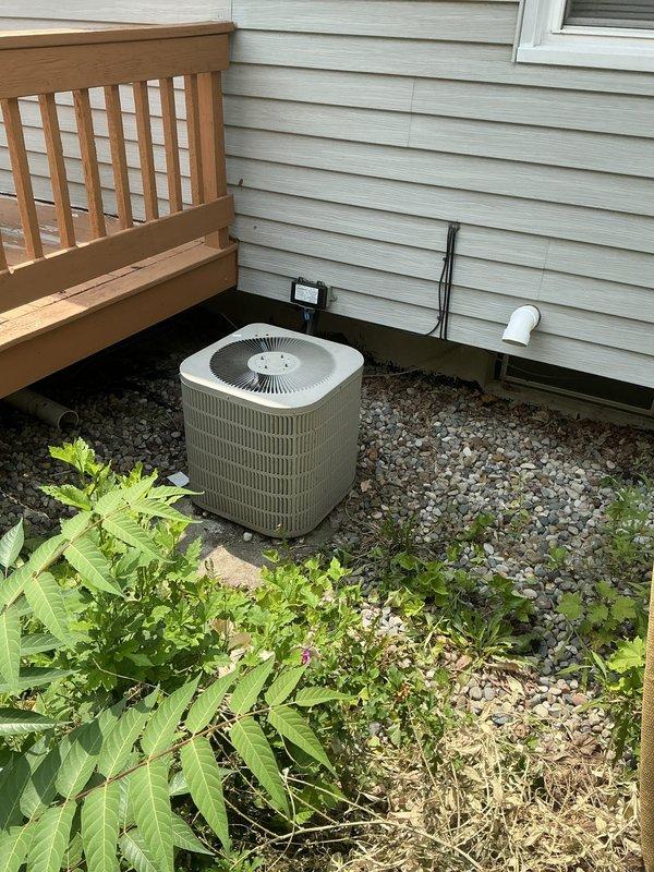 Responded to no-cooling complaint on 21-year-old Goodman air conditioning system that had previously failed two days after recent service. Performed comprehensive diagnostic evaluation of outdoor condenser unit and indoor air handler components. Documented existing system conditions through photographic evidence showing outdoor unit placement, electrical connections, condensate drainage system, and indoor HVAC infrastructure including ductwork, furnace connections, and associated plumbing. Provided detailed sales estimate for air conditioning system replacement due to age and reliability concerns of existing equipment.