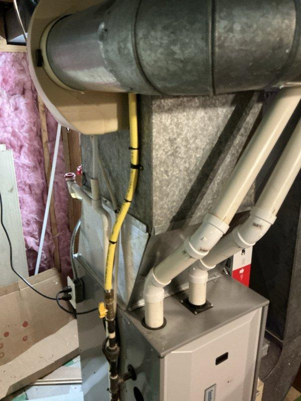 Responded to no-cooling complaint on 21-year-old Goodman air conditioning system that had previously failed two days after recent service. Performed comprehensive diagnostic evaluation of outdoor condenser unit and indoor air handler components. Documented existing system conditions through photographic evidence showing outdoor unit placement, electrical connections, condensate drainage system, and indoor HVAC infrastructure including ductwork, furnace connections, and associated plumbing. Provided detailed sales estimate for air conditioning system replacement due to age and reliability concerns of existing equipment.