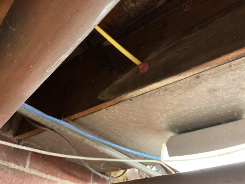 Completed inspector-required corrections including securing exposed electrical wiring with proper stapling, installing draft stop at return air penetration, labeling electrical circuit at panel, and installing code-compliant service receptacle. All items verified and brought into compliance with local building code requirements.