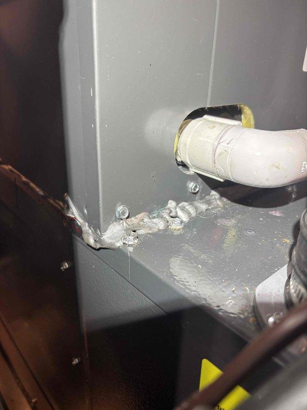 Responded to water leak issue on recently installed EnergiAir AC unit that was causing moisture sensor to trigger system shutdown. Upon inspection, discovered excessive condensation and water accumulation at air handler cabinet where refrigerant line penetrations enter the unit. Identified improper sealing around insulated line set penetration point allowing moisture infiltration and condensate leakage at cabinet seam. Corrected installation deficiency by properly sealing penetration points and ensuring condensate drainage system was functioning correctly, eliminating water accumulation that was triggering the safety sensor.
