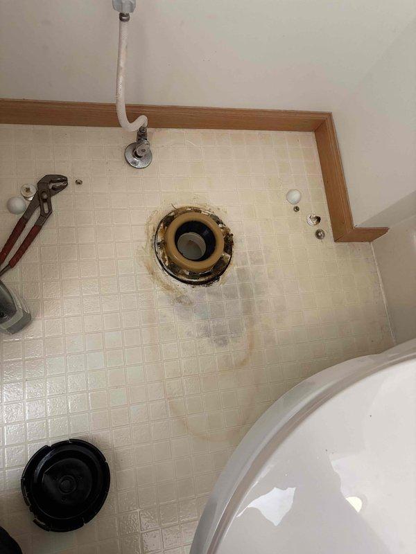 Responded to report of toilet leaking bright orange liquid at base in residential bathroom. Upon arrival, removed toilet to inspect flange and identify source of leak. Found deteriorated wax ring with significant rust-colored staining and corrosion around toilet flange area. Orange discoloration on floor tiles confirmed ongoing water seepage from failed seal. Removed old wax ring, cleaned flange and surrounding area of rust deposits and mineral buildup. Inspected flange for structural integrity and proper mounting. Installed new wax ring and reinstalled toilet, ensuring proper seal and secure mounting to prevent future leaks. Tested flush operation and verified no leakage at base. Explained to homeowner that discoloration was caused by corroded metal components in plumbing system mixing with water, creating the distinctive orange residue observed.