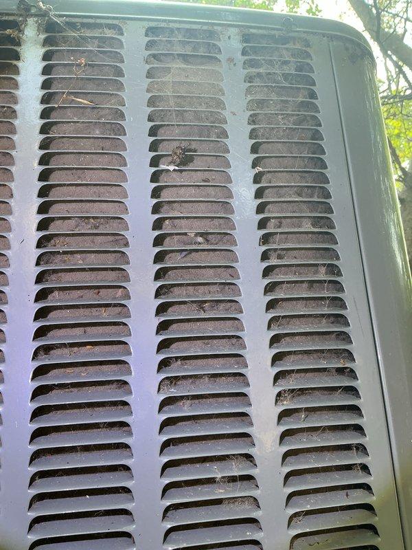 Completed annual cooling maintenance on 2019 outdoor condensing unit. Performed comprehensive system inspection, cleaned condenser coils and louvers removing accumulated debris, dirt, and cobwebs from exterior panels and ventilation grilles. Verified unit operation and documented equipment condition with photos showing weathered exterior consistent with outdoor exposure.