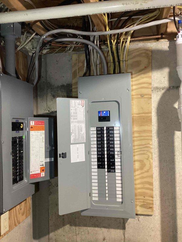 Conducted site evaluation for standby generator installation estimate. Assessed existing electrical service configuration, including main service panels, circuit breaker capacity, and utility metering system. Documented current electrical infrastructure consisting of multiple panels with digital monitoring capabilities and 240V 3-wire service rated at 320 amps. Photographed basement utility area showing available installation space, panel locations, conduit routing, and service entrance configuration to determine optimal generator placement and transfer switch integration requirements for future Kohler standby generator system.