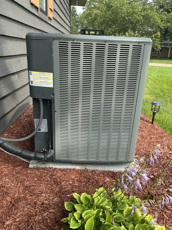 Completed annual cooling maintenance on EnergiAir system with 2-year tune-up inspection. Performed comprehensive evaluation of outdoor condensing unit, verified proper operation of all components, and inspected electrical connections and refrigerant lines. Unit found in good working condition with proper airflow through condenser coil. Documented equipment condition with photos showing outdoor unit installation on concrete pad with proper clearances and landscaping maintenance around unit. All safety labels intact and visible. System operating within normal parameters.