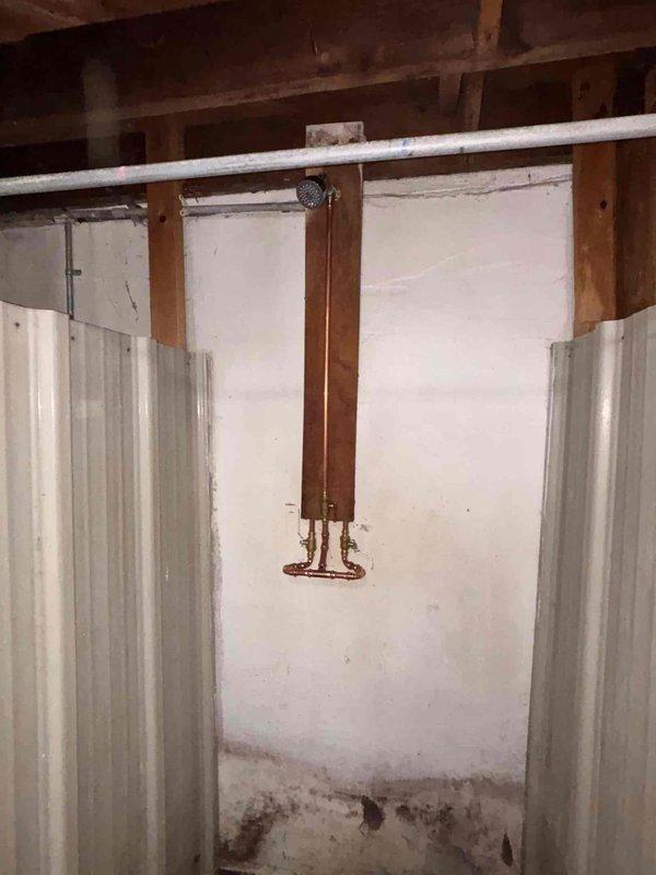 Completed plumbing system repair in basement crawl space area involving copper pipe installation and associated infrastructure work. Addressed water damage concerns visible on foundation surfaces and installed proper pipe mounting and support systems. Work included coordination with existing PVC drainage lines, structural framing modifications, and ceiling cavity access for utility routing to ensure proper integration with building's plumbing infrastructure.
