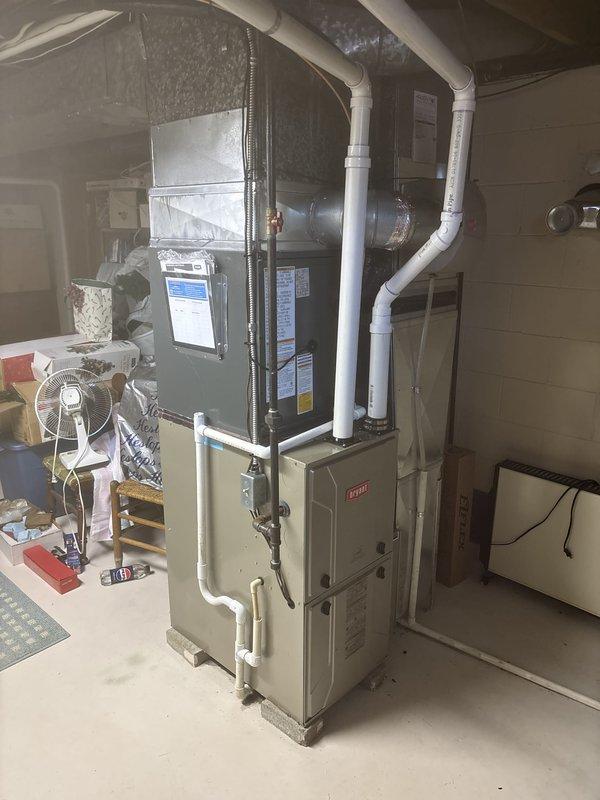 Completed full installation of air source heat pump system in residential basement mechanical room. Installed and configured new furnace unit with integrated air handler, including all necessary ductwork connections utilizing flexible metallic ducting and overhead distribution system. Established proper refrigerant charging per manufacturer specifications with factory charge of 83 oz and field charge of 43 oz for total system charge of 126 oz. Installed complete PVC condensate drain and venting system with proper routing and support. Connected all copper refrigerant lines with brass fittings and appropriate insulation. Verified all electrical connections, tested system operation, and confirmed proper airflow through distribution system. System is fully operational and ready for service.
