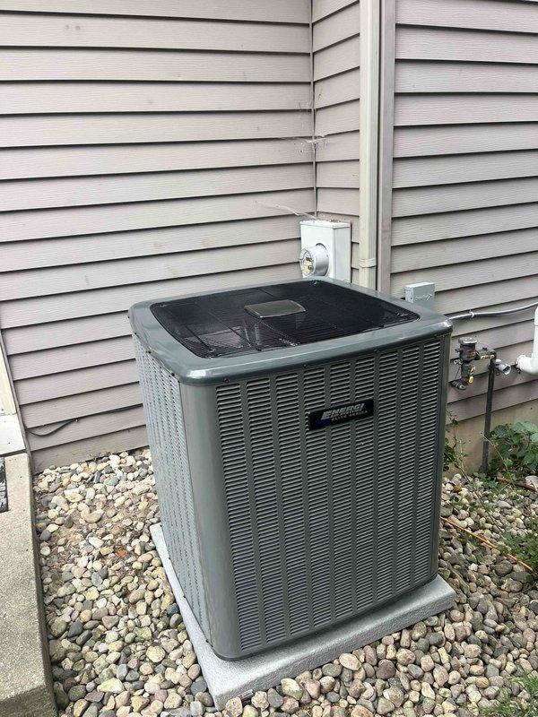 Completed full HVAC system installation including new furnace and air conditioning condenser unit. Installed outdoor AC condenser on gravel pad against building exterior with proper refrigerant line connections and electrical hookup. Inside mechanical room, installed new furnace with complete PVC venting system secured to wall framing, connected condensate drainage lines, and integrated ductwork to existing distribution system. All equipment tested and verified operational upon completion.