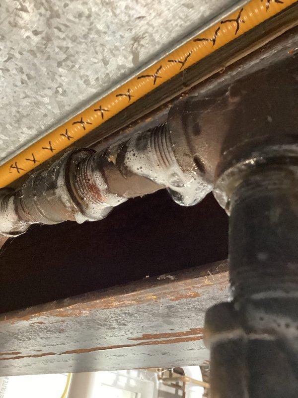Responded to gas leak call on 22-year-old Nordyne furnace system. Identified and confirmed gas leak at furnace gas valve that ceased when supply valve was shut off. Additionally discovered pinhole leak in CSST flexible gas supply line serving multiple gas appliances, with approximately 8 feet of affected line located interior and 40 feet running exterior post-meter. Documented system conditions with photos showing HVAC components and infrastructure. Recommended complete replacement of compromised gas supply line and furnace gas valve repair to eliminate leak hazards and restore safe operation.