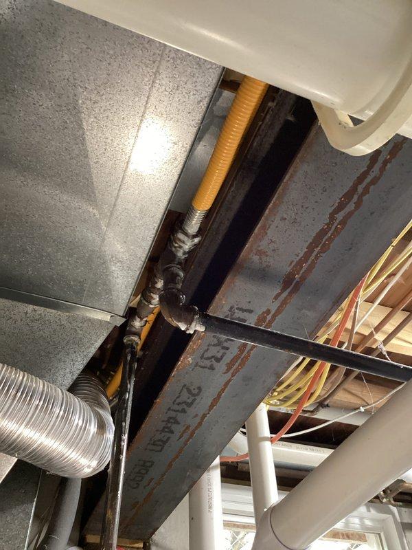 Responded to gas leak call on 22-year-old Nordyne furnace system. Identified and confirmed gas leak at furnace gas valve that ceased when supply valve was shut off. Additionally discovered pinhole leak in CSST flexible gas supply line serving multiple gas appliances, with approximately 8 feet of affected line located interior and 40 feet running exterior post-meter. Documented system conditions with photos showing HVAC components and infrastructure. Recommended complete replacement of compromised gas supply line and furnace gas valve repair to eliminate leak hazards and restore safe operation.