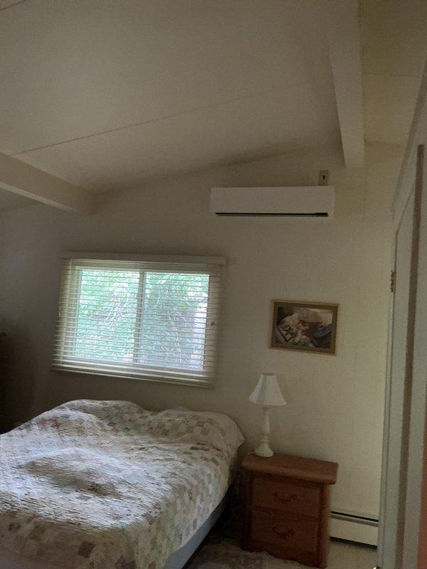 Successfully completed installation of ductless mini-split system at residential property. Mounted outdoor condensing unit in side yard area with proper drainage provisions and secure mounting to exterior wall. Installed indoor wall-mounted air handler in bedroom, positioned above window for optimal air distribution. Ran refrigerant line set and electrical connections between outdoor and indoor units through exterior wall penetration. System was pressure tested, evacuated, and charged with refrigerant per manufacturer specifications. Verified proper operation of heating and cooling modes, confirmed adequate airflow from indoor unit, and tested all system controls and safety features. Unit is operating efficiently and providing climate control to the bedroom space.