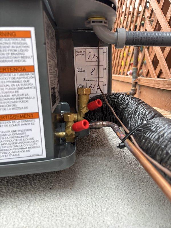Completed full residential air conditioning system replacement. Removed existing unit and installed new outdoor condenser on concrete pad against exterior wall with proper electrical disconnect and line set connections. Charged system with refrigerant per manufacturer specifications (53 oz factory charge, 8 oz field charge, 61 oz total charge). Verified all electrical connections, service valves, and safety controls operational. System tested and confirmed cooling properly upon startup.