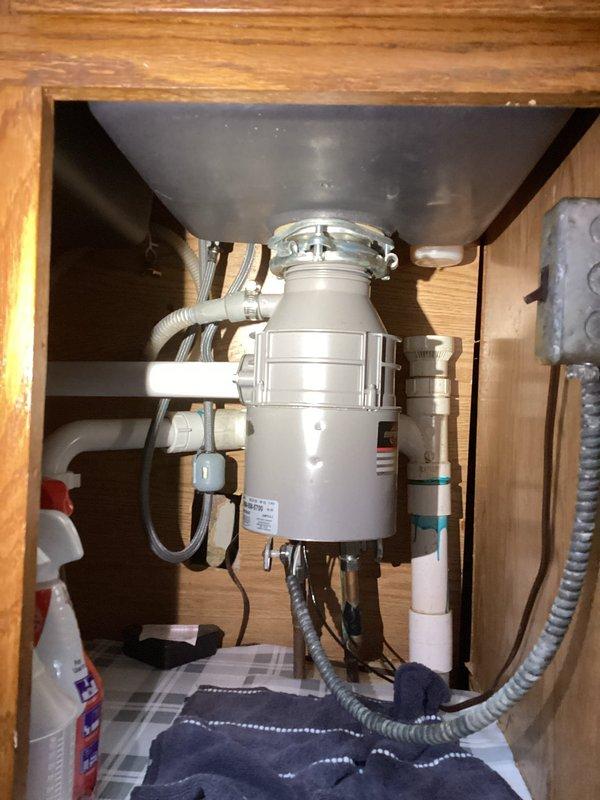 Responded to service call for toilet making coughing noise and leaking sink. Upon inspection, identified issues with toilet fill valve causing air in the water line and addressed leak at kitchen sink drain connections beneath the cabinet. Inspected garbage disposal unit and associated plumbing connections, tightened loose fittings, and verified proper drainage. Tested toilet flush cycle and sink drainage to confirm all issues resolved and systems operating properly.