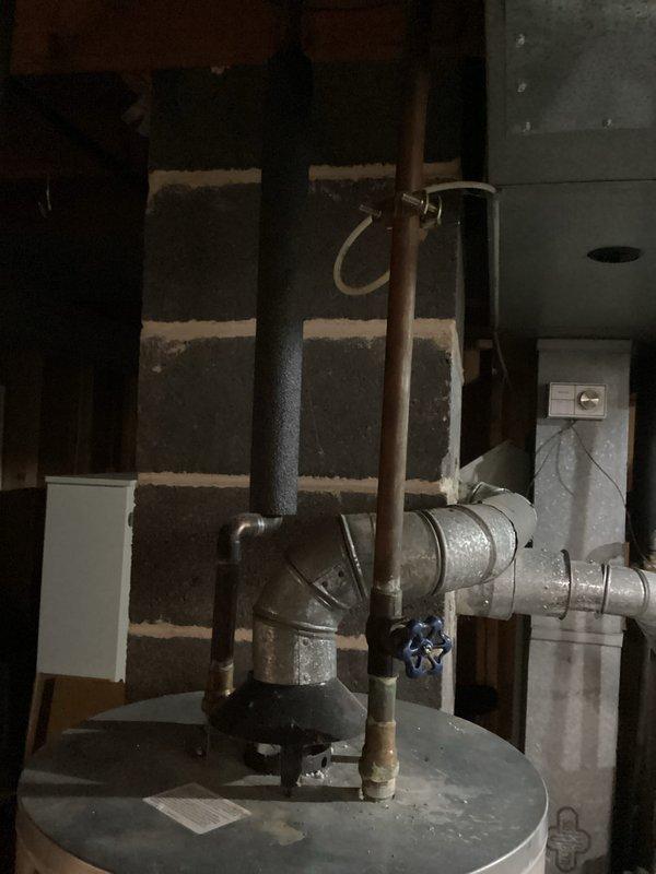 # Water Heater No Hot Water Service Call

Responded to service call for 10-year-old water heater not producing hot water. Upon arrival, performed visual inspection of unit and surrounding plumbing connections in basement utility area. Observed water heater with proper plumbing connections including cold water inlet with blue shutoff valve, hot water outlet piping, and temperature/pressure relief valve discharge line.

Conducted diagnostic assessment of water heater system. Checked electrical connections and power supply to unit. Inspected condition of heating elements and thermostat controls. Verified proper operation of circuit breaker and reset if necessary. Tested water heater functionality after completing diagnostic procedures.

Noted presence of condensation on nearby ductwork, indicating proper humidity levels in mechanical room but no direct impact on water heater operation. All plumbing connections appeared secure with no visible leaks at inlet/outlet connections or relief val