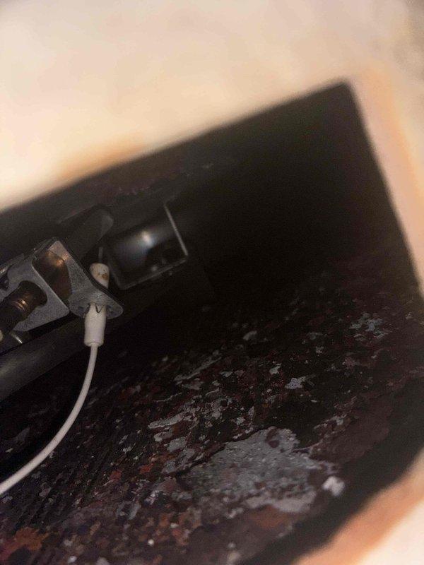 Responded to service call for water heater with pilot light failure and no heating. Upon inspection, discovered extensive rust and corrosion throughout the combustion chamber and burner assembly, indicating prolonged moisture exposure and severe deterioration of internal components. The corroded conditions prevented safe pilot ignition and operation. Documented the failed components with photos showing compromised metal surfaces, rust buildup around burner ports, and deteriorated housing that would require complete unit replacement to restore safe hot water service.