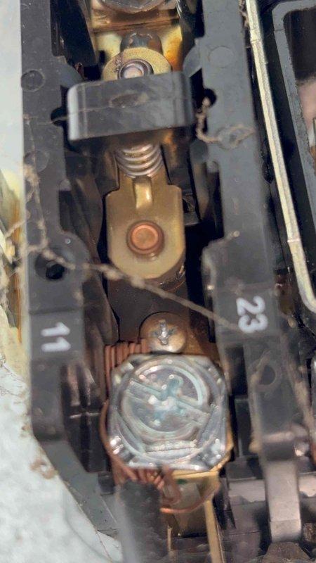 Responded to no cooling call with complete system failure reported. Upon inspection, found failed contactor with severely corroded and oxidized terminal connections preventing proper operation. Contactor showed significant wear with darkened metal components and deteriorated contact points. Replaced defective contactor and inspected dual-run capacitor rated at 30+5 MFD, which tested within acceptable range. Cleaned all electrical connections, secured wiring terminals, and verified proper voltage at disconnect. Cycled system through complete operational test, confirmed compressor engagement, and verified normal amperage draw. System restored to full cooling operation with no further issues detected.