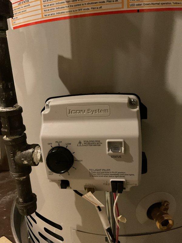 Completed installation of a 40-gallon natural gas water heater, Bradford White model M2-40S6N. Unit was properly positioned with required clearances, gas and water connections secured, ICON System control unit mounted and configured, and all safety labels verified in place. System tested and confirmed operational with pilot light ignited and normal heating cycle functioning correctly.
