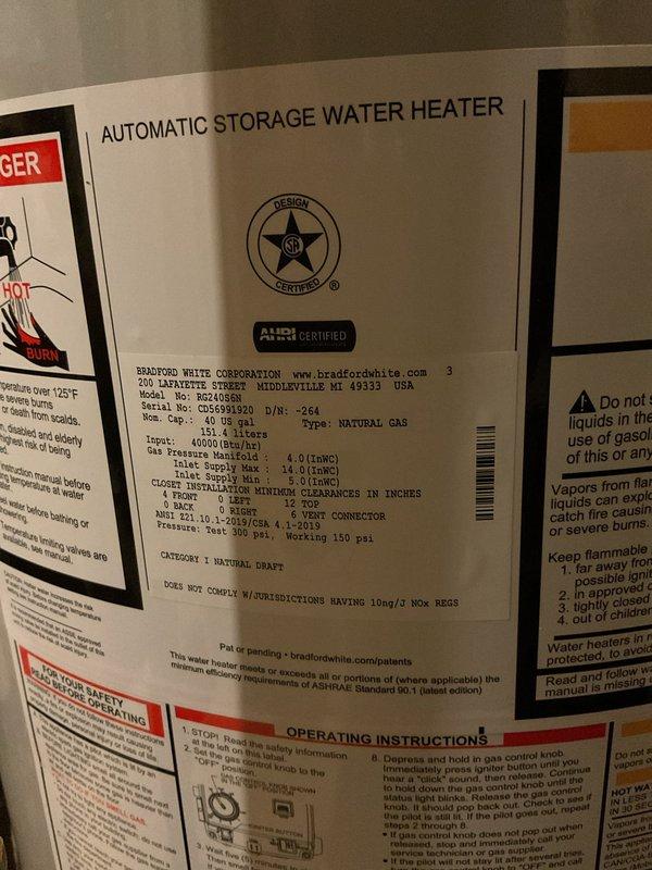 Completed installation of a 40-gallon natural gas water heater, Bradford White model M2-40S6N. Unit was properly positioned with required clearances, gas and water connections secured, ICON System control unit mounted and configured, and all safety labels verified in place. System tested and confirmed operational with pilot light ignited and normal heating cycle functioning correctly.