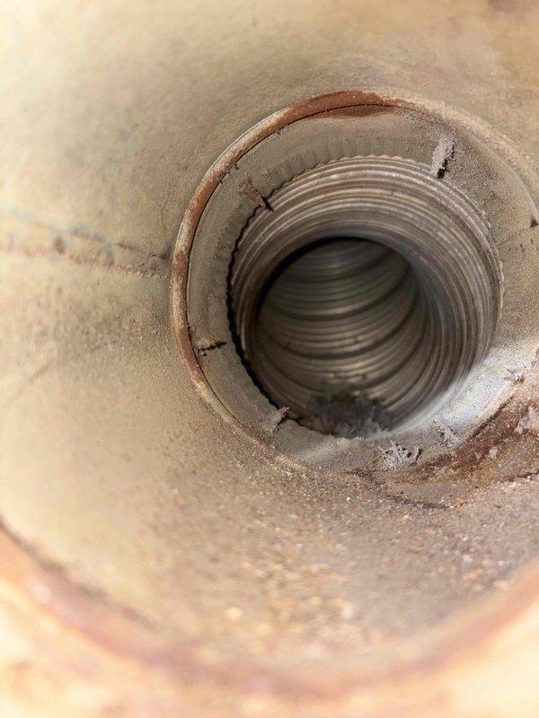 Responded to no-ignition complaint on residential water heater. Upon inspection, found unit experiencing ignition failure. Removed and inspected burner assembly, identifying corroded thermocouple and debris accumulation in pilot assembly preventing proper flame sensing. Cleaned burner orifice, pilot assembly, and flame sensor. Replaced failed thermocouple and tested gas valve operation. Verified proper venting and combustion air supply. Cycled unit multiple times, confirmed reliable ignition, and verified temperature rise. Unit restored to normal operation with proper pilot flame and main burner ignition sequence.