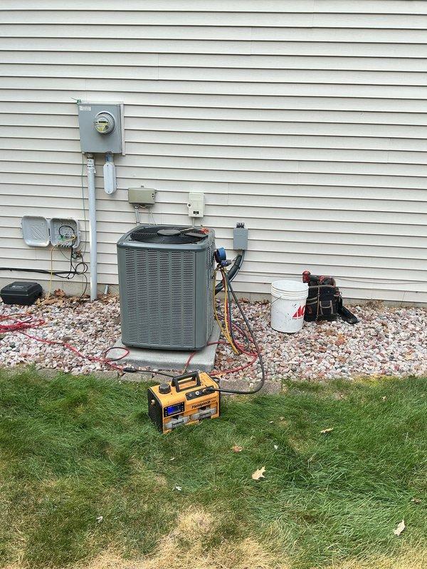 Completed full HVAC system replacement including indoor air handler unit and outdoor condensing unit. Installed new vertical furnace/air handler in utility room with proper wall mounting, connected PVC exhaust venting through exterior wall, and established condensate drainage system with PVC piping. Mounted outdoor condensing unit on concrete pad with white gravel base for proper drainage and airflow clearance. Ran refrigerant line set between indoor and outdoor units, installed electrical disconnect boxes and proper conduit for power supply connections. Verified all electrical connections to meter box, tested system operation with diagnostic equipment, and confirmed proper refrigerant charge levels and system performance parameters.