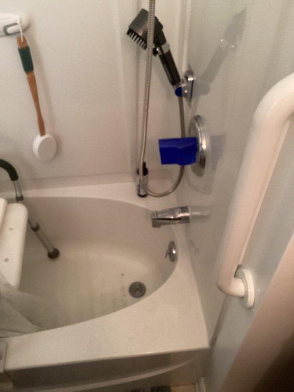 Responded to service call regarding suspected metal debris on bathtub floor originating from drain area. Performed visual inspection of tub drain assembly and surrounding plumbing fixtures, including chrome drain components and tub spout. Assessed basement plumbing infrastructure including PVC drainage lines, support strapping, and pipe connections to identify potential source of metallic material. Documented conditions with photographic evidence showing bathtub interior with chrome fixtures and exposed ceiling plumbing system. No immediate drain corrosion or structural failure observed during inspection.
