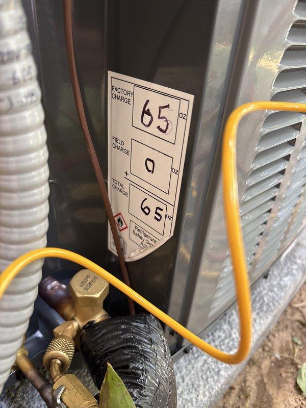 Completed add-on air conditioning system installation at residential property. Installed new outdoor condensing unit on concrete pad with proper electrical disconnect box mounted to exterior siding. Connected refrigerant lines using manifold gauges for system charging and testing. Verified factory charge of 65 oz and added 9 oz field charge per manufacturer specifications for total system charge of 65 oz. Installed flexible ductwork connections to integrate new AC system with existing infrastructure. Performed system startup, pressure testing, and operational verification to ensure proper cooling performance and refrigerant flow. All components functioning within normal operating parameters upon completion.