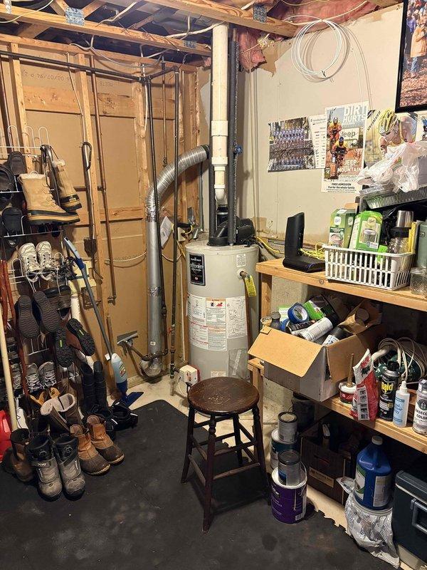 Conducted on-site evaluation of existing standard tank water heater in basement utility area for replacement with tankless water heater system. Assessed current water heater installation including PVC venting configuration, gas supply line accessibility, and electrical requirements. Documented existing setup with photos showing current tank unit, surrounding utility space layout, and venting system utilizing PVC piping through ceiling joists. Additionally evaluated furnace conversion feasibility from propane to natural gas fuel source, examining current gas line infrastructure and equipment compatibility requirements for dual conversion project.
