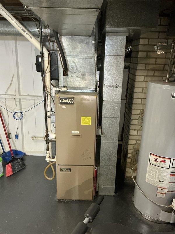 Conducted comprehensive estimate for furnace and air conditioning system replacement at residential property. Evaluated existing basement HVAC installation, including current furnace unit with connected ductwork and associated utility infrastructure. Assessed exterior equipment location and access points in side yard area with existing landscaping and foundation clearances. Documented current system configuration, ductwork routing, electrical connections, and venting arrangements to provide accurate replacement specifications and installation requirements.