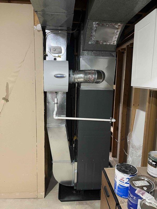 Completed full HVAC system installation including new high-efficiency Energy Star rated furnace and air conditioning unit in basement utility area. Installed air handler with integrated AprilAire humidifier system, connected all supply and return ductwork using galvanized metal and flexible ducting, and ran PVC condensate and exhaust piping from furnace unit. All equipment properly mounted, leveled, and secured per manufacturer specifications with electrical connections completed and system tested for proper operation.