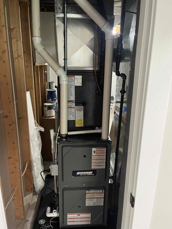 Completed full HVAC system installation including new high-efficiency Energy Star rated furnace and air conditioning unit in basement utility area. Installed air handler with integrated AprilAire humidifier system, connected all supply and return ductwork using galvanized metal and flexible ducting, and ran PVC condensate and exhaust piping from furnace unit. All equipment properly mounted, leveled, and secured per manufacturer specifications with electrical connections completed and system tested for proper operation.