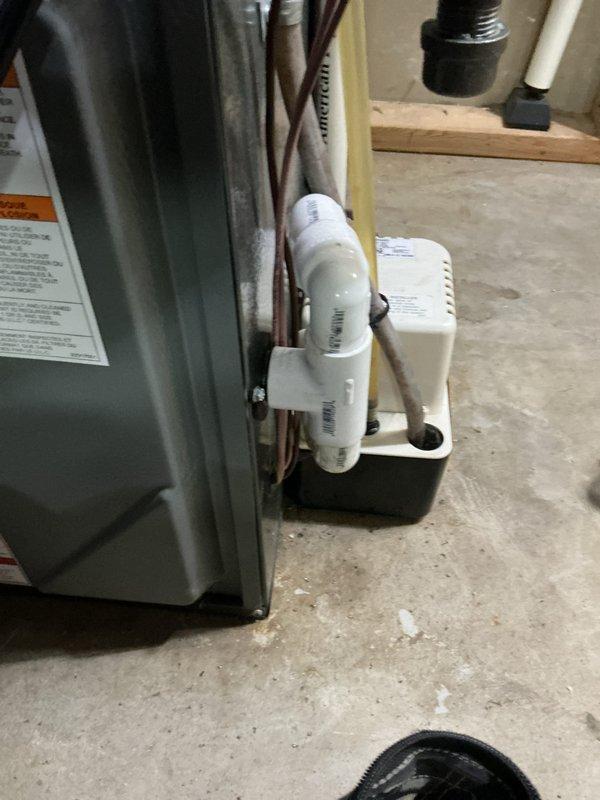 Completed annual cooling maintenance on residential HVAC system. Performed comprehensive tune-up inspection of air conditioning equipment, including examination of refrigerant lines, condensate drain trap assembly, and evaporator coil. Inspected copper refrigerant lines, electrical connections, and white PVC condensate drainage system for proper operation. Examined evaporator coil fins and noted minor dust accumulation between fin surfaces. Verified proper condensate trap installation and drainage function. Documented equipment condition with photographs showing furnace/air handler unit, refrigerant piping, and coil condition. System operational and ready for cooling season. Enrolled customer in club membership program covering furnace, air conditioning, and humidifier equipment for ongoing maintenance coverage.