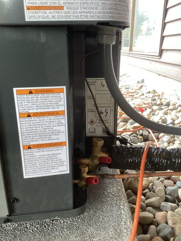 Completed full air conditioning system replacement at residential property. Removed existing outdoor condensing unit and installed new replacement unit on existing concrete pad with proper refrigerant line connections, electrical hookup via wall-mounted junction box, and condensate drainage. Verified all safety labels and manufacturer specifications are visible and compliant. System tested and confirmed operational upon completion.