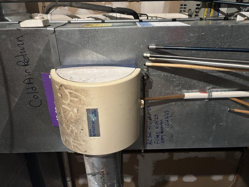 Completed annual cooling maintenance on 20-year-old Trane system. Performed comprehensive inspection of air handler unit and condensate drain assembly, documented system conditions with photos showing coil air return section and refrigerant line connections. All components operating within normal parameters at time of inspection.