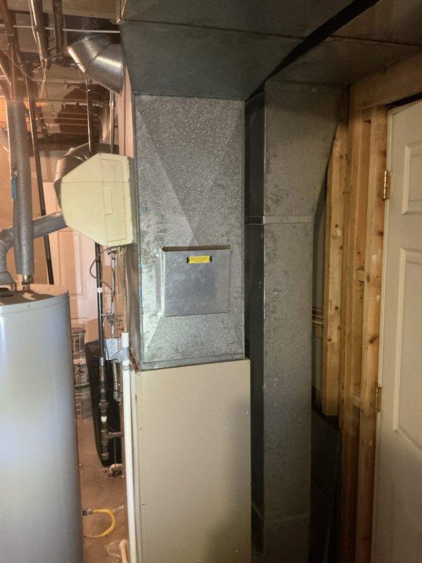 Completed in-home estimate for replacement of existing 30-year-old furnace and 33-year-old Amana air conditioning system, both original to the home from 1994. Assessed current HVAC equipment located in basement mechanical room, documented existing two-tone vertical furnace unit and associated ductwork configuration. Evaluated system layout including copper refrigerant lines, flexible ductwork connections, and overall installation conditions to provide comprehensive replacement recommendations for new heating and cooling equipment.